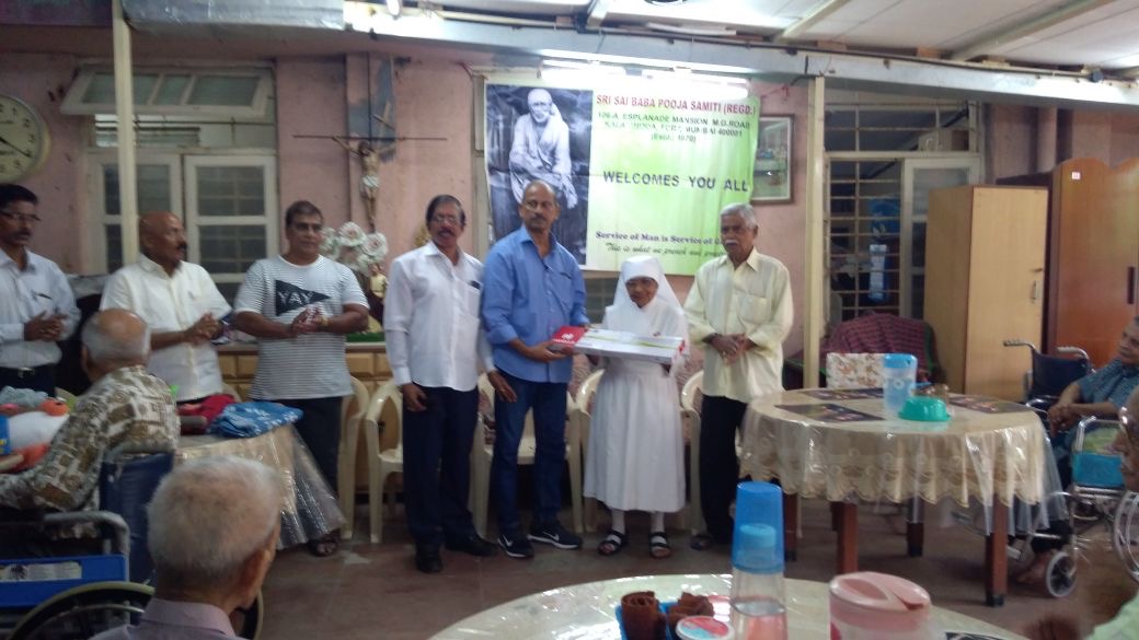 Samiti members presenting aid at a home for the aged